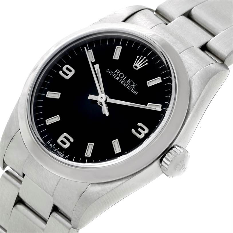 The image shows a close-up view of the Rolex Oyster Perpetual 67180 Women's Stainless Steel Black Dial 67180 Women's Stainless Steel Black Dial watch, showcasing its dial, bezel, crown, and part of the bracelet.