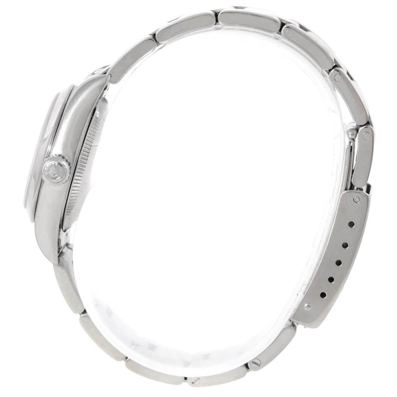 This is a side view of the Rolex Oyster Perpetual 76080 Women's Stainless Steel Pink Dial 76080 Women's Stainless Steel Pink Dial watch displaying the case, bezel, crown, and bracelet.