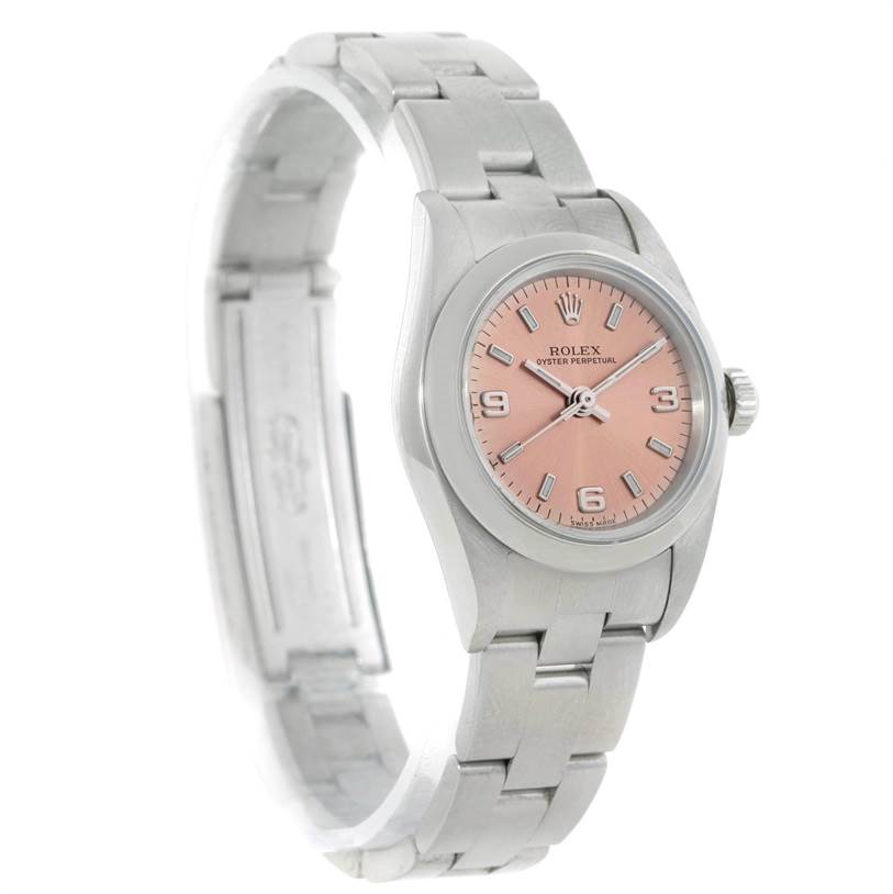 This image shows a Rolex Oyster Perpetual 76080 Women's Stainless Steel Pink Dial 76080 Women's Stainless Steel Pink Dial watch with a pink dial, displayed at an angle highlighting the watch face and part of the bracelet.