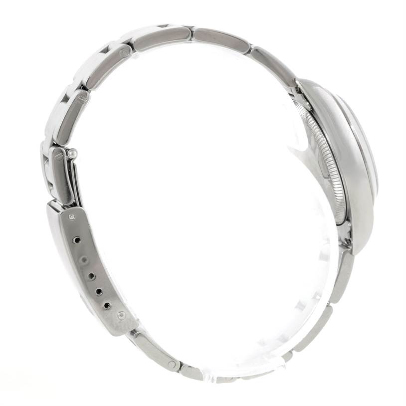 This side view of the Rolex Oyster Perpetual 76080 Women's Stainless Steel Pink Dial 76080 Women's Stainless Steel Pink Dial watch shows the bracelet and case without the watch face.