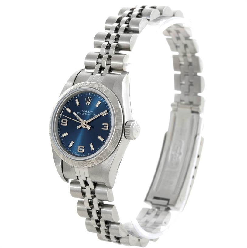 This image shows a side angle of the Rolex Oyster Perpetual 67230 Women's Stainless Steel Blue Dial 67230 Women's Stainless Steel Blue Dial watch, highlighting the blue dial, crown, and part of the bracelet.