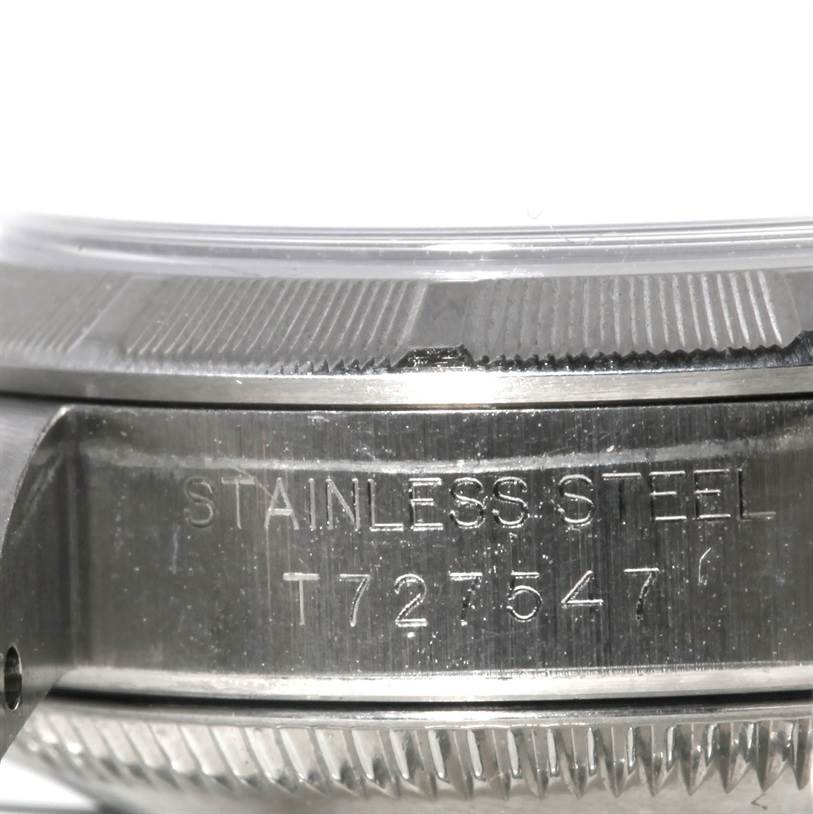 This image shows a close-up side view of the case back and part of the bezel of a Rolex Oyster Perpetual 67230 Women's Stainless Steel Blue Dial 67230 Women's Stainless Steel Blue Dial watch.