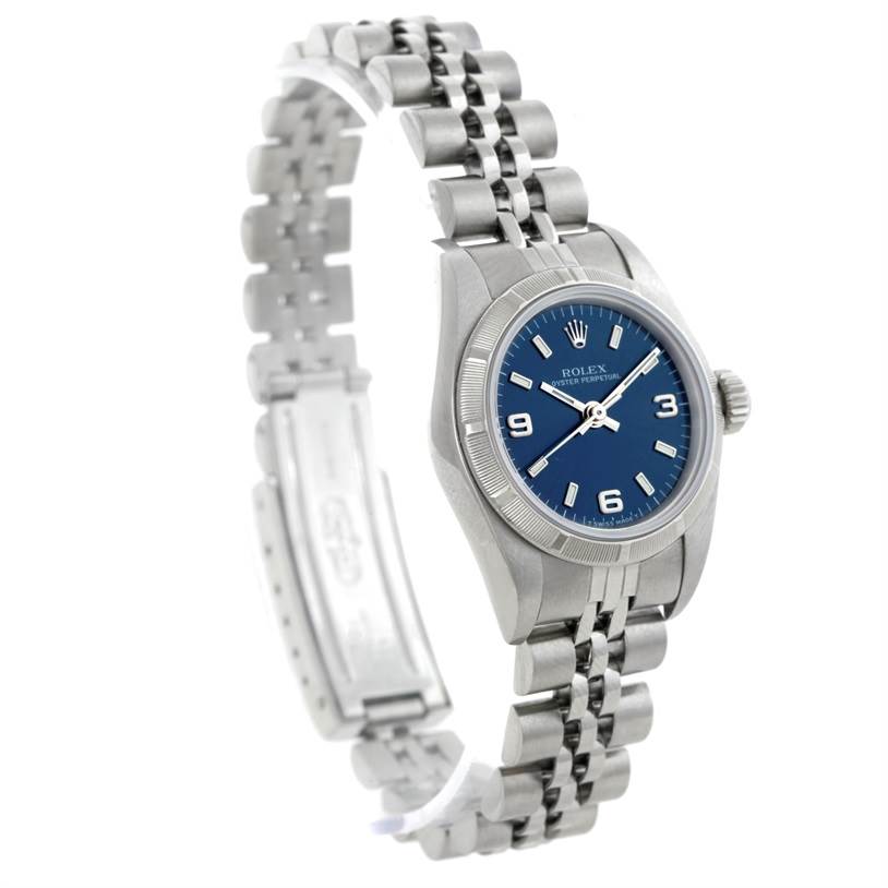 The Rolex Oyster Perpetual 67230 Women's Stainless Steel Blue Dial 67230 Women's Stainless Steel Blue Dial watch is shown at an angled view, highlighting its silver bracelet, blue dial, and clasp.
