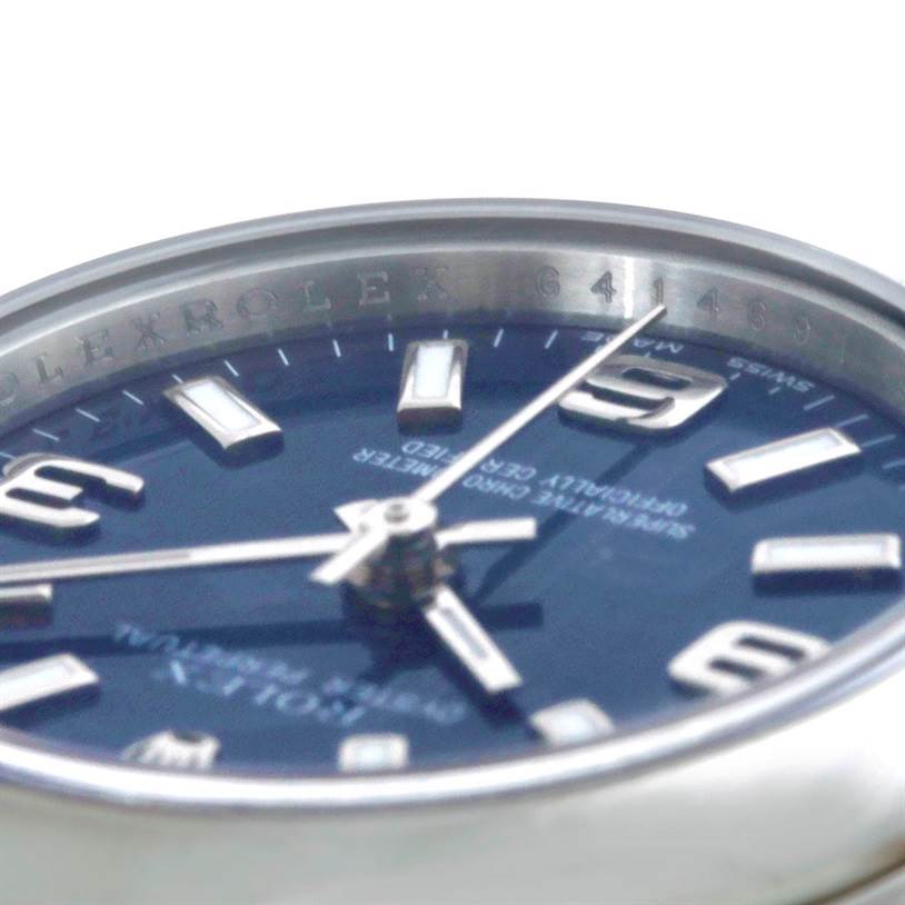 The image shows a close-up angle of the dial and bezel of a Rolex Oyster Perpetual 176200 Women's Stainless Steel Blue Dial 176200 Women's Stainless Steel Blue Dial watch.