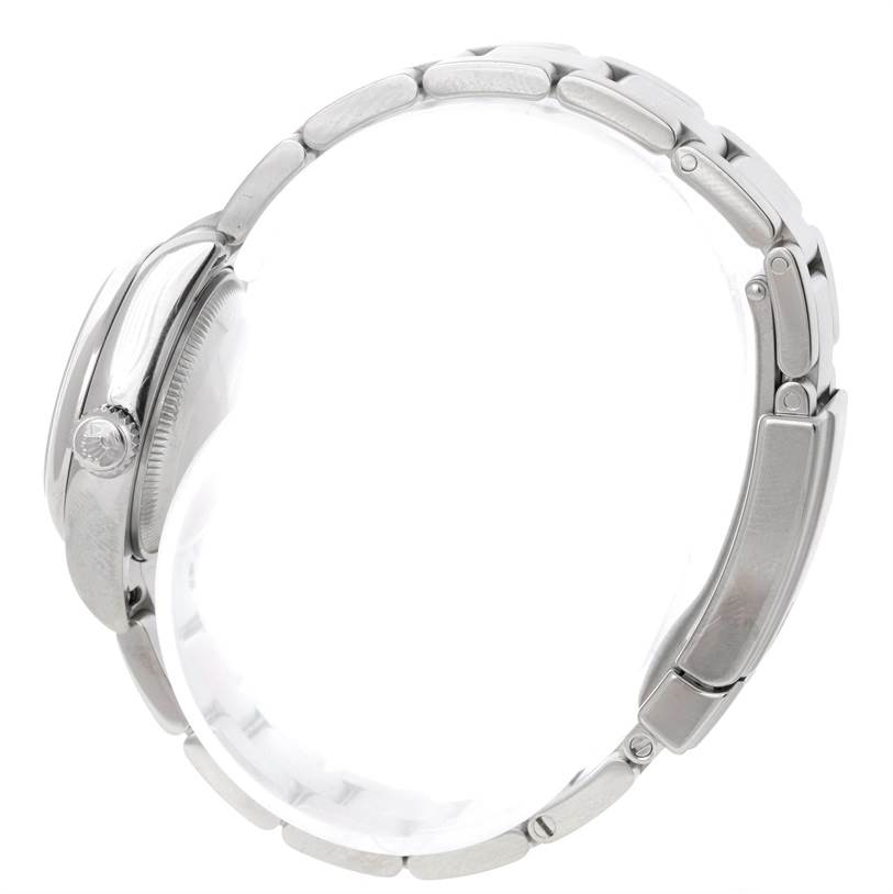 This side profile of the Rolex Oyster Perpetual 176200 Women's Stainless Steel Blue Dial 176200 Women's Stainless Steel Blue Dial watch showcases its crown and bracelet links.