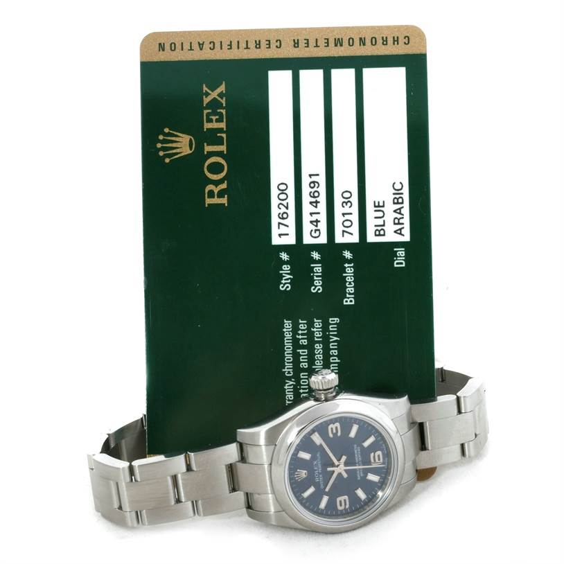 The image shows a Rolex Oyster Perpetual 176200 Women's Stainless Steel Blue Dial 176200 Women's Stainless Steel Blue Dial watch lying flat with its certification card visible in the background.