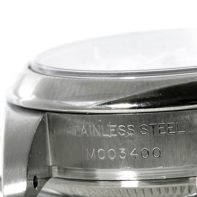 This close-up image shows a side view of the stainless steel casing of a Rolex Oyster Perpetual 176200 Women's Stainless Steel White Dial 176200 Women's Stainless Steel White Dial watch, with visible serial engraving.
