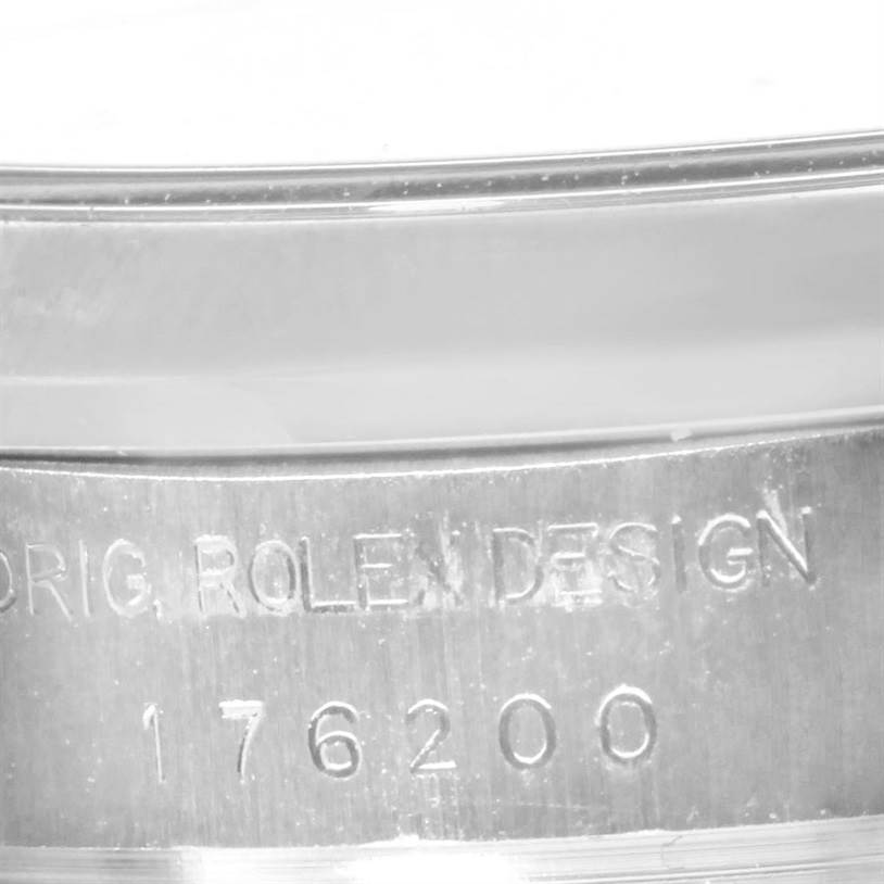The image shows a close-up of the serial number engraving on the case of a Rolex Oyster Perpetual 176200 Women's Stainless Steel Silver Dial 176200 Women's Stainless Steel Silver Dial watch.