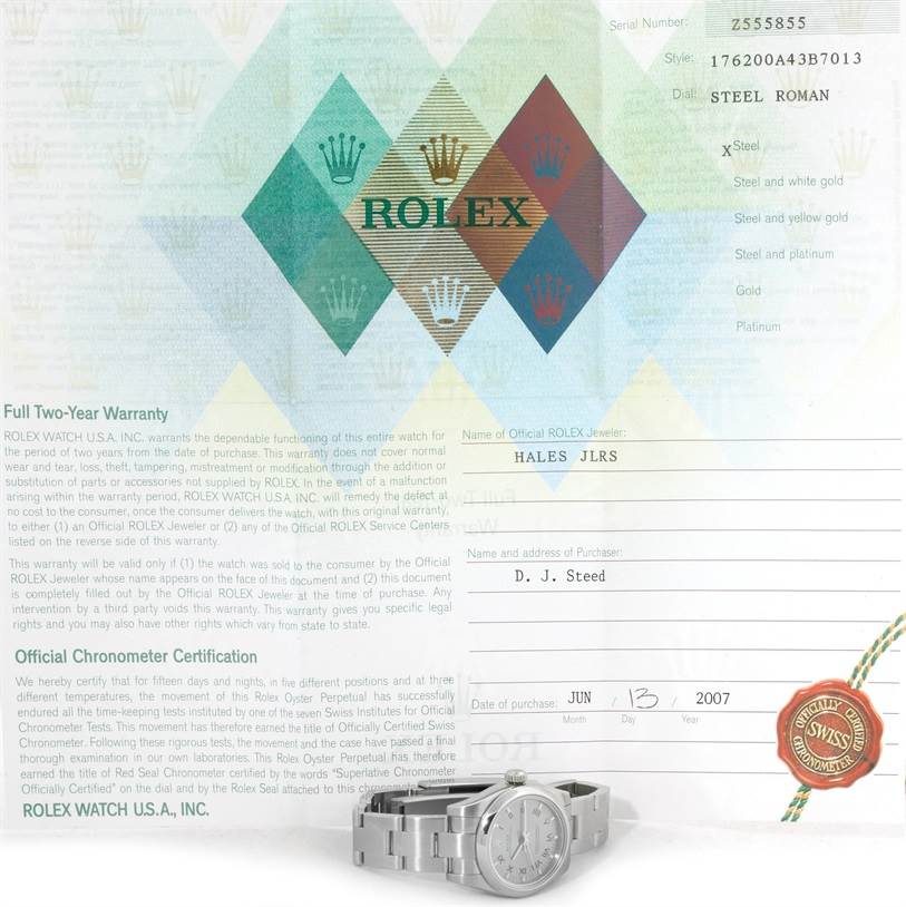 The Rolex Oyster Perpetual 176200 Women's Stainless Steel Silver Dial 176200 Women's Stainless Steel Silver Dial watch is shown flat with its warranty and certification documents from a front angle.