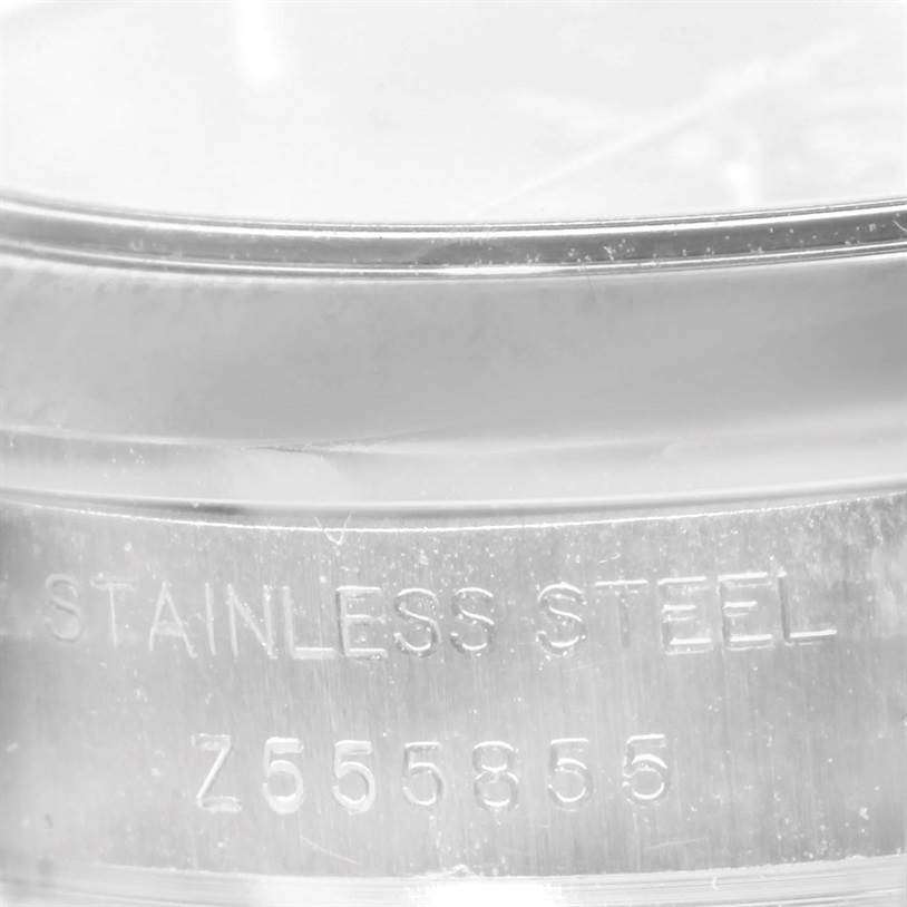 This image shows a close-up of the stainless steel case back of a Rolex Oyster Perpetual 176200 Women's Stainless Steel Silver Dial 176200 Women's Stainless Steel Silver Dial watch with the serial number visible.