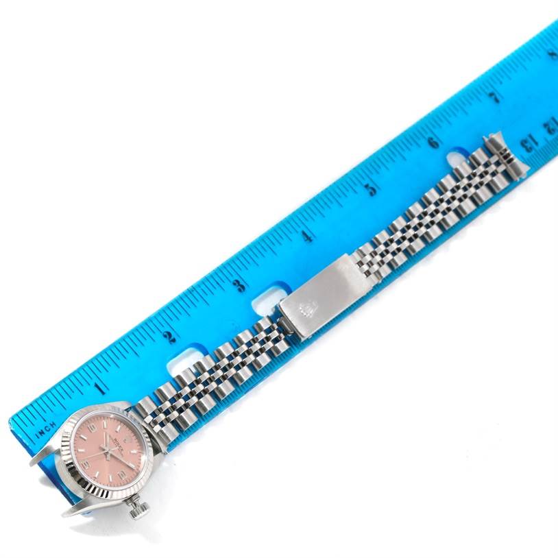 The image shows a Rolex Oyster Perpetual 67194 Women's Stainless Steel Pink Dial 67194 Women's Stainless Steel Pink Dial watch lying flat next to a blue ruler for scale.