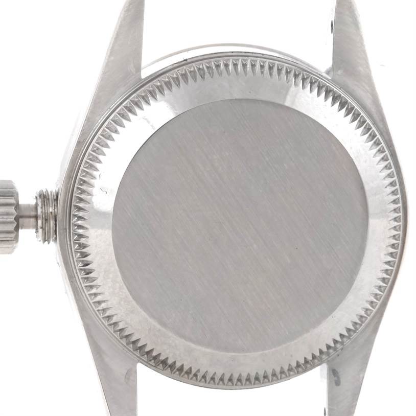 The image shows the back case of a Rolex Oyster Perpetual 67194 Women's Stainless Steel Pink Dial 67194 Women's Stainless Steel Pink Dial watch, viewed from the rear, with the winding crown visible.