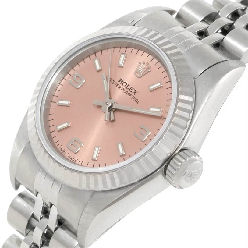 This image shows a close-up angle of the Rolex Oyster Perpetual 67194 Women's Stainless Steel Pink Dial 67194 Women's Stainless Steel Pink Dial watch, highlighting the pink dial, crown, and part of the bracelet.