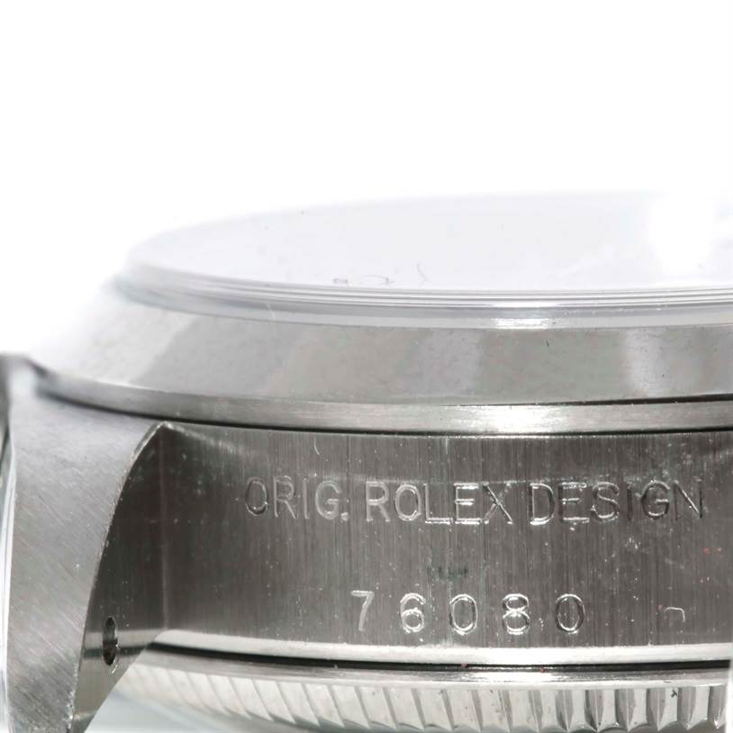 The image shows a close-up side view of the Rolex Oyster Perpetual 76080 Women's Stainless Steel Pink Dial 76080 Women's Stainless Steel Pink Dial's case, focusing on the model number and "ORIG. ROLEX DESIGN" engraving.