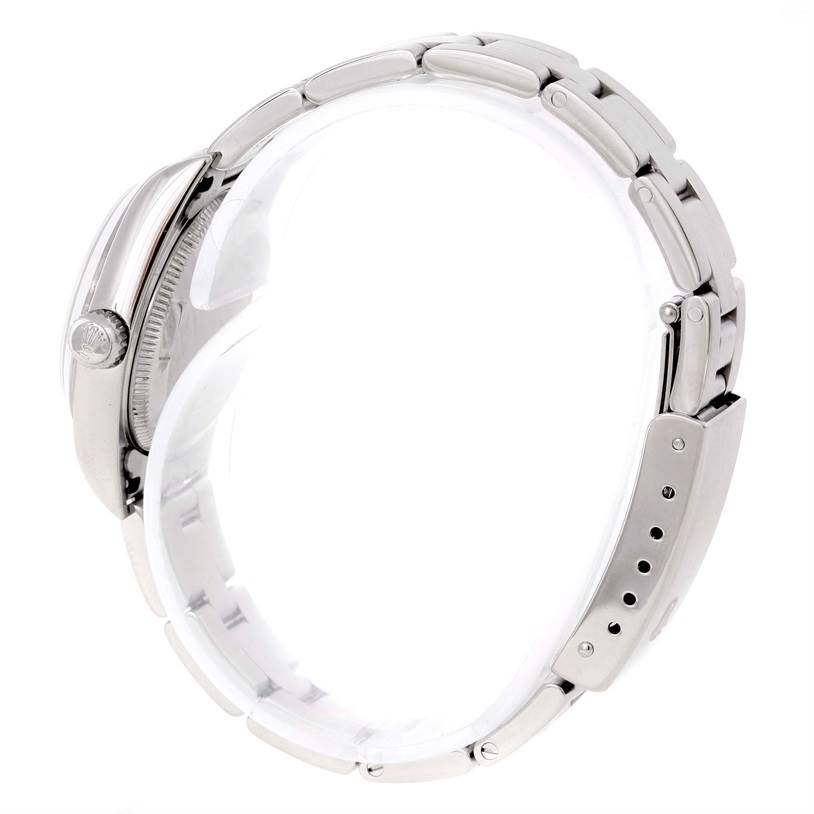 This side view of the Rolex Oyster Perpetual 76080 Women's Stainless Steel Pink Dial 76080 Women's Stainless Steel Pink Dial watch shows the case, bracelet, crown, and clasp.