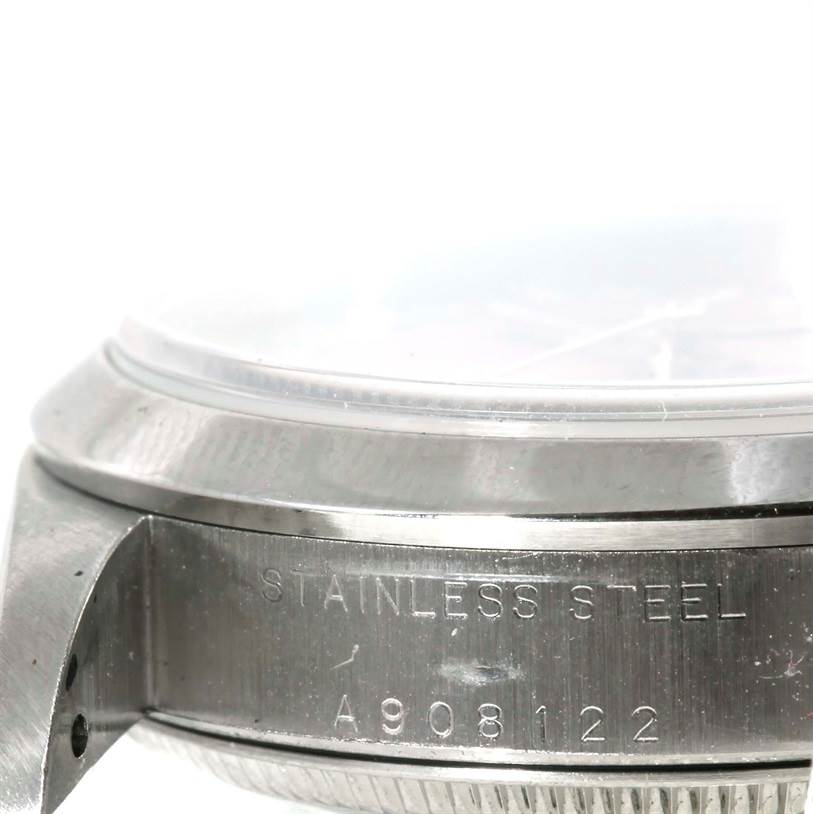 This image shows a side view of the casing of a Rolex Oyster Perpetual 67180 Women's Stainless Steel Pink Dial 67180 Women's Stainless Steel Pink Dial watch, highlighting the stainless steel material and serial number.