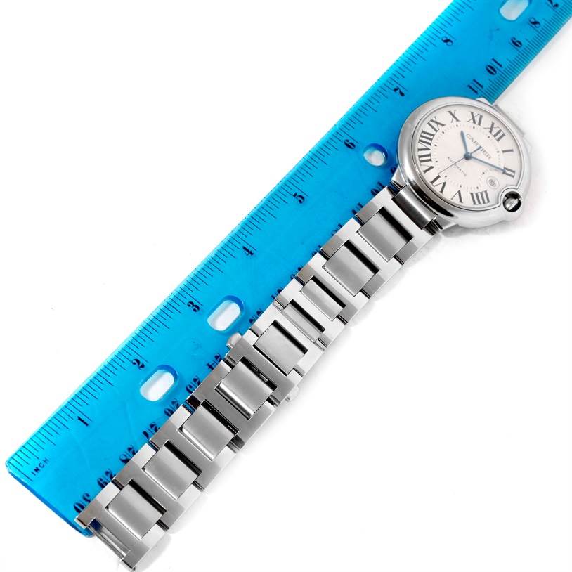 The image shows the Cartier Ballon Bleu W69012Z4 Men
s Stainless Steel Silver Dial W69012Z4 Men
s Stainless Steel Silver Dial watch face and part of its metal bracelet from a top-down angle.