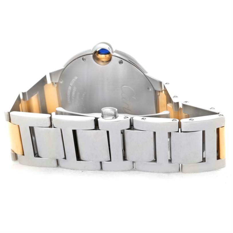 The image shows the back view of a Ballon Bleu by Cartier watch, highlighting the two-tone metal bracelet and crown.