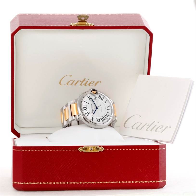 The Cartier Ballon Bleu 10524 Men's Stainless Steel Silver Dial 10524 Men's Stainless Steel Silver Dial watch is displayed in its open box, showing the face, band, and accompanying booklet.