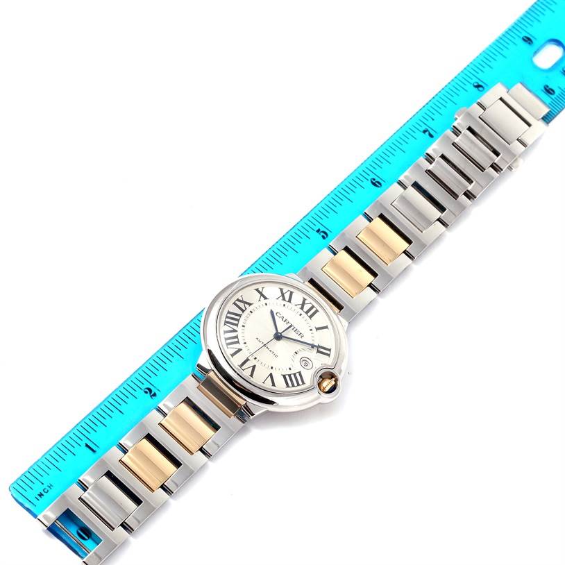 The image shows a top view of the Cartier Ballon Bleu W69009Z3 Stainless Steel Silver Dial W69009Z3 Stainless Steel Silver Dial watch, including its face and band, placed next to a blue ruler for scale.