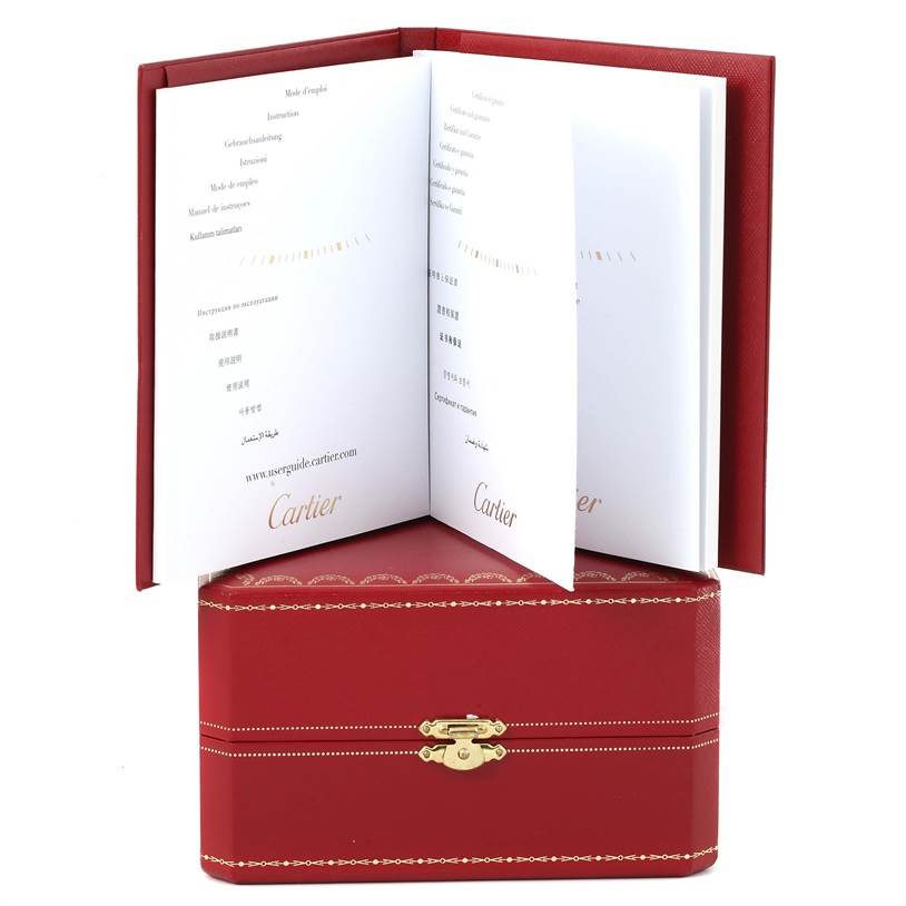The image shows the instruction booklet and the red storage box for the Ballon Bleu model by Cartier.