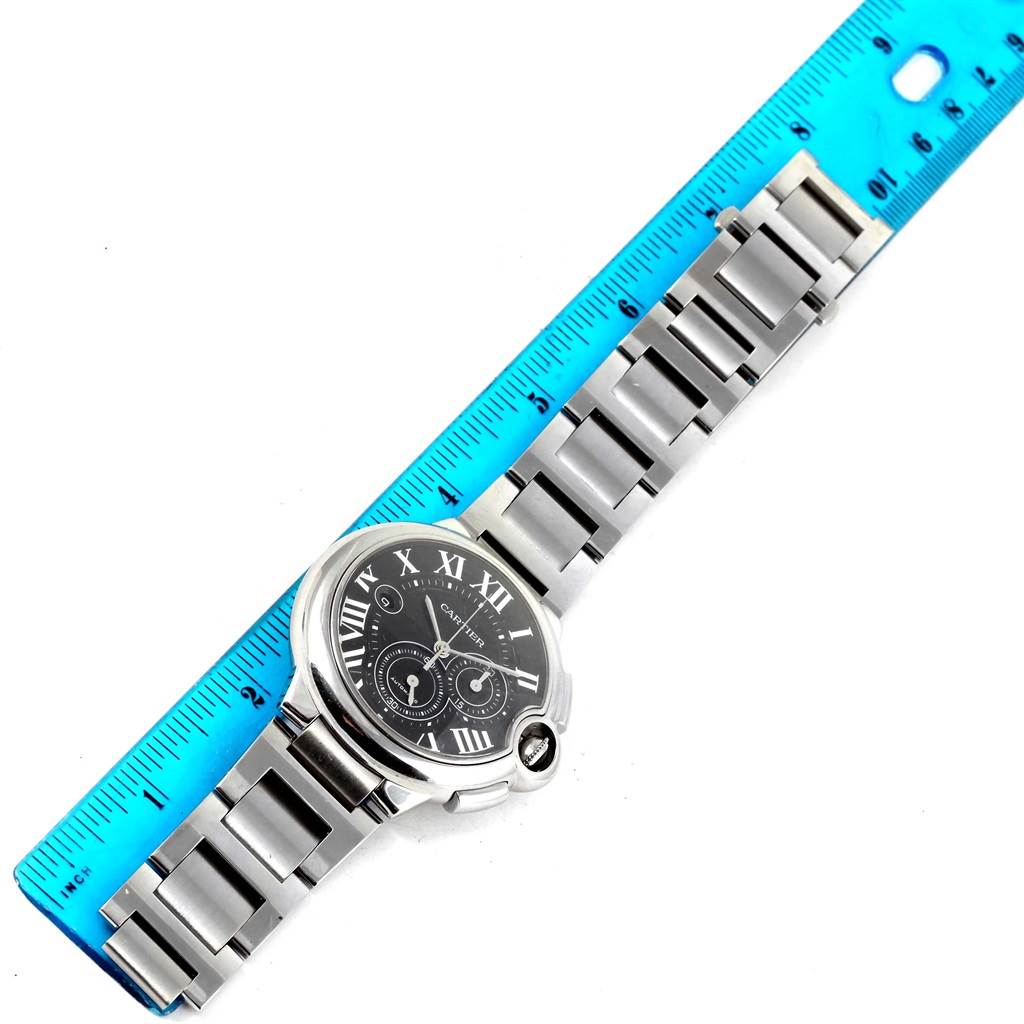 This image showcases the front view of a Cartier Ballon Bleu W6920077 Men's Stainless Steel Black Dial W6920077 Men's Stainless Steel Black Dial watch placed alongside a ruler for scale.