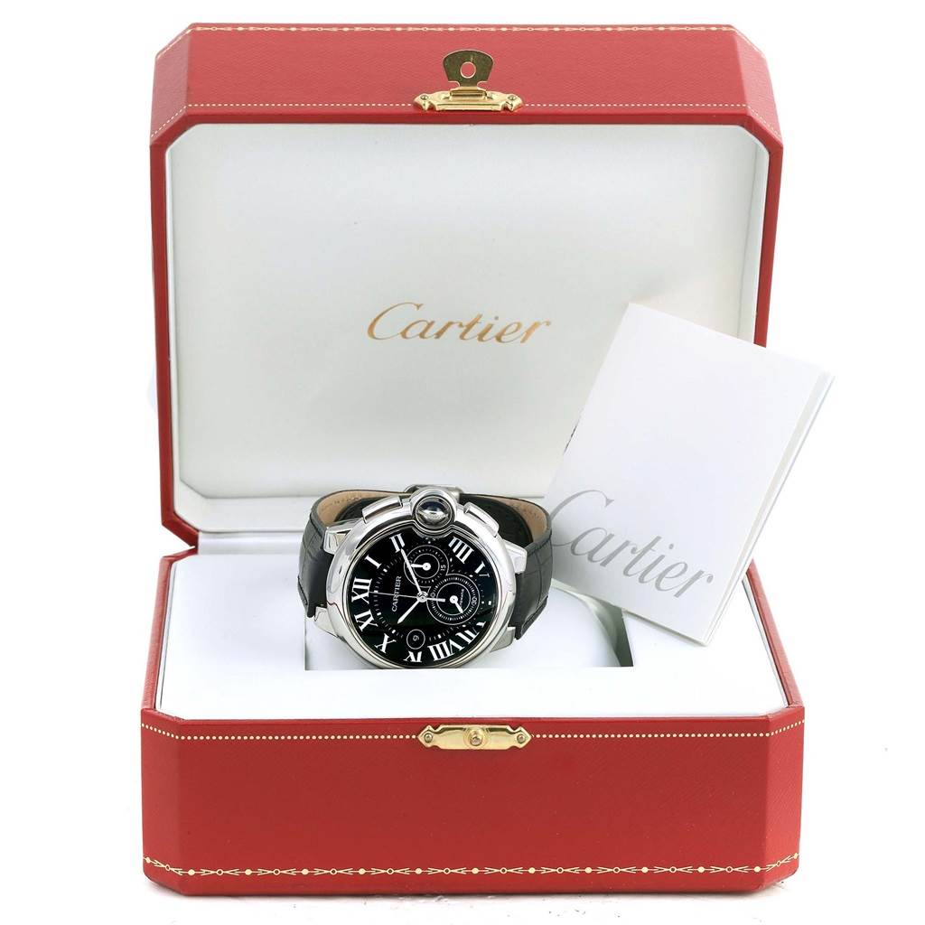 The image shows a Cartier Ballon Bleu W6920052 Men's Stainless Steel Black Dial W6920052 Men's Stainless Steel Black Dial watch in an open Cartier box, with booklets beside it.