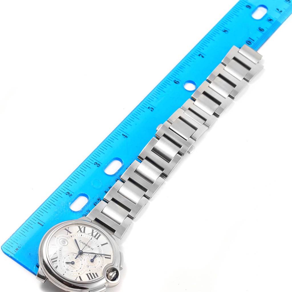 This image shows the face and bracelet of a Cartier Ballon Bleu W6920002 Stainless Steel Silver Dial W6920002 Stainless Steel Silver Dial watch next to a blue ruler for measurement.