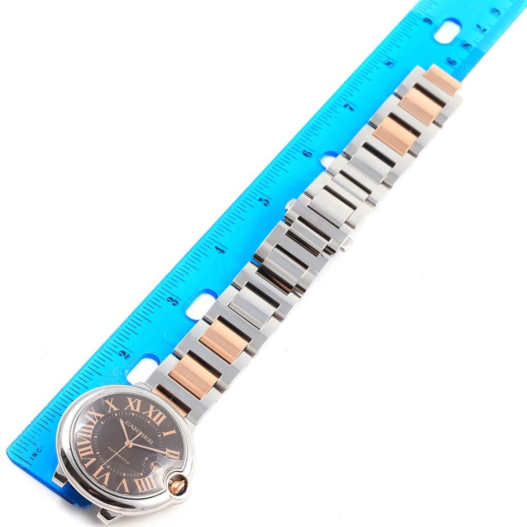 The image shows a Cartier Ballon Bleu W6920032 Steel and Gold (two tone) Brown Dial W6920032 Steel and Gold (two tone) Brown Dial watch and its bracelet laid flat next to a ruler for measurement.