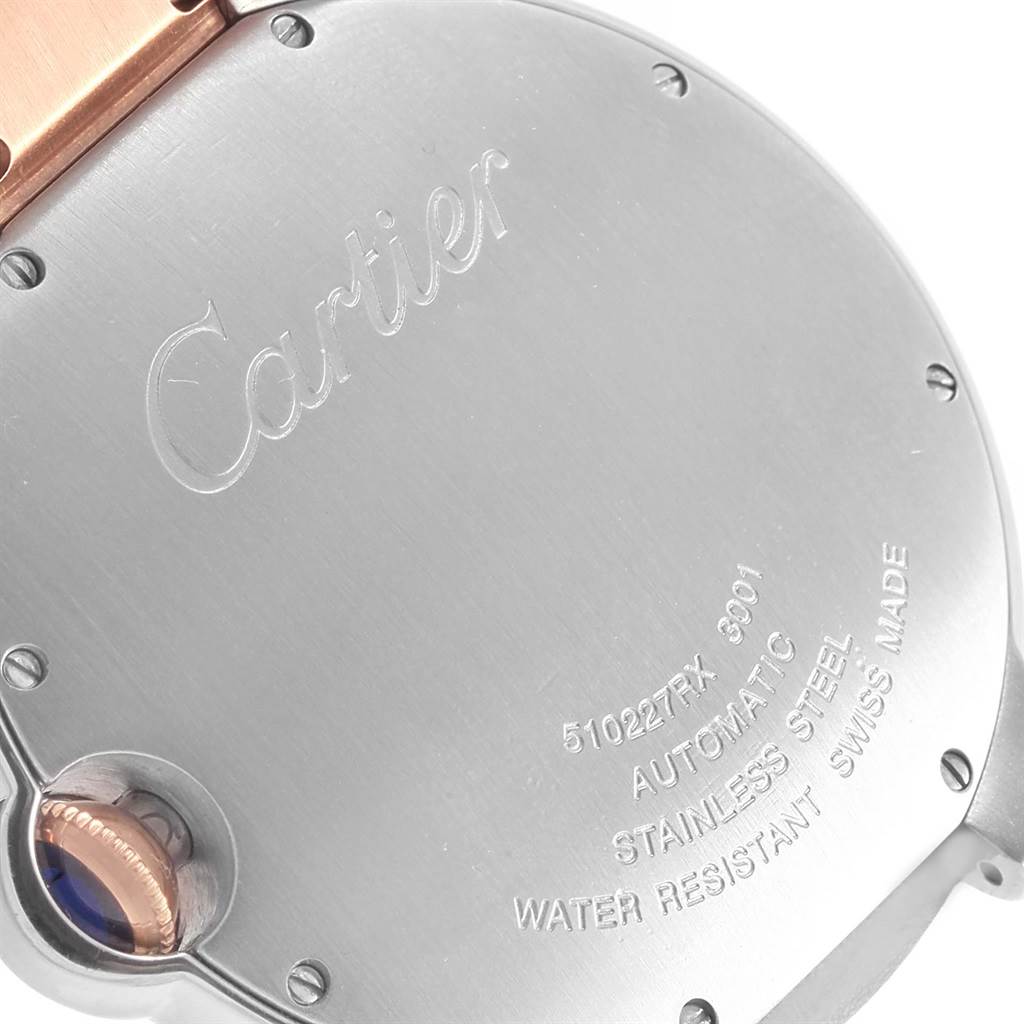 The image shows the back case of a Ballon Bleu model by Cartier, highlighting the engraved details.