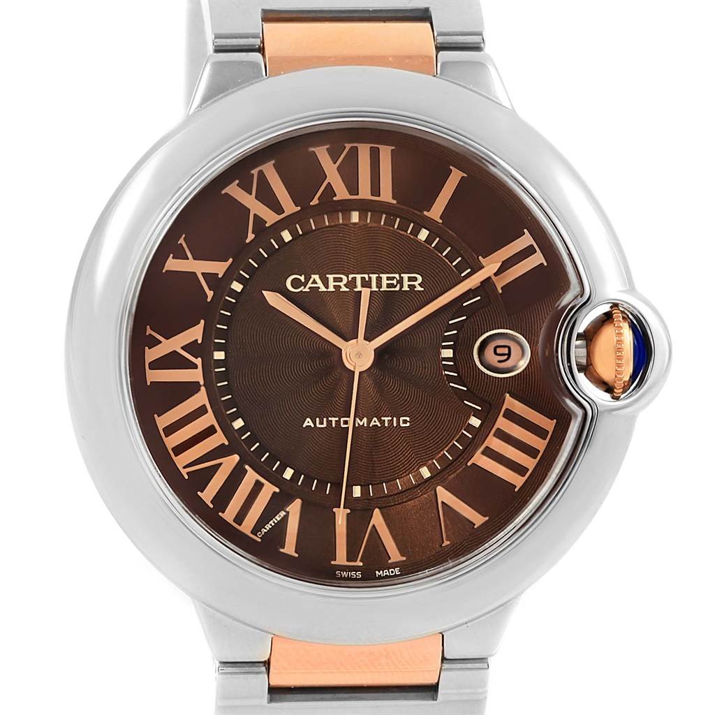The image shows a front view of the Cartier Ballon Bleu W6920032 Steel and Gold (two tone) Brown Dial W6920032 Steel and Gold (two tone) Brown Dial watch, featuring a brown dial, Roman numerals, and a date window.