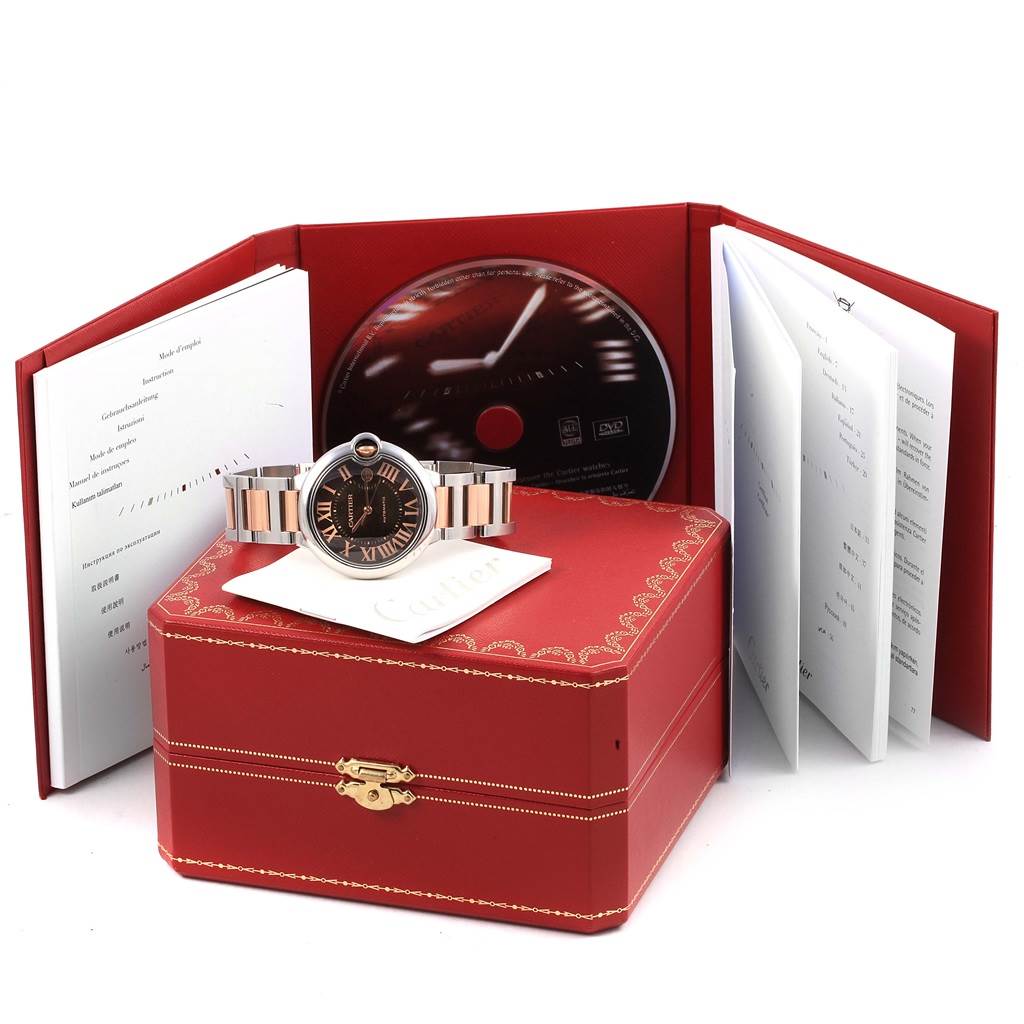 The image shows a Cartier Ballon Bleu W6920032 Steel and Gold (two tone) Brown Dial W6920032 Steel and Gold (two tone) Brown Dial watch with its box, manual, CD, and documentation, all displayed at a front angle.