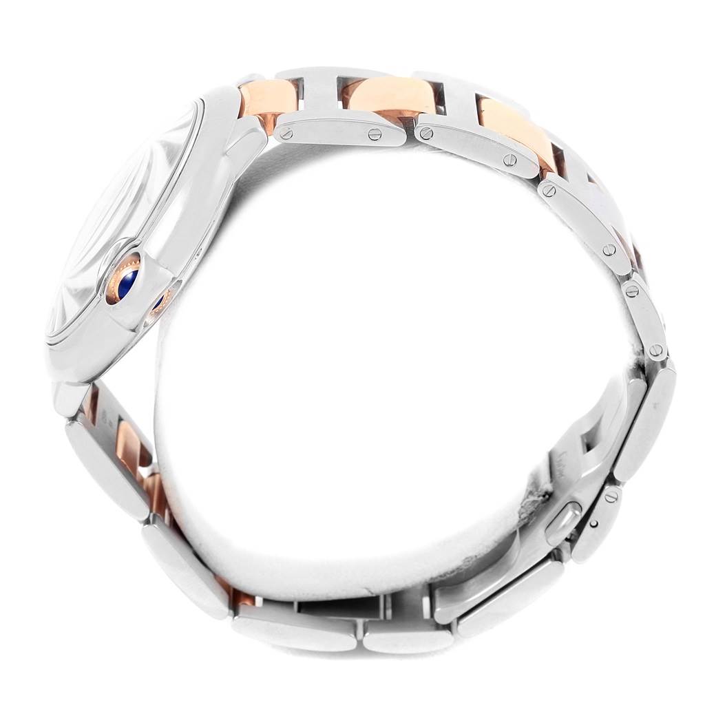 This side view of the Cartier Ballon Bleu W6920032 Steel and Gold (two tone) Brown Dial W6920032 Steel and Gold (two tone) Brown Dial watch shows the crown and part of the bracelet with its two-tone links.