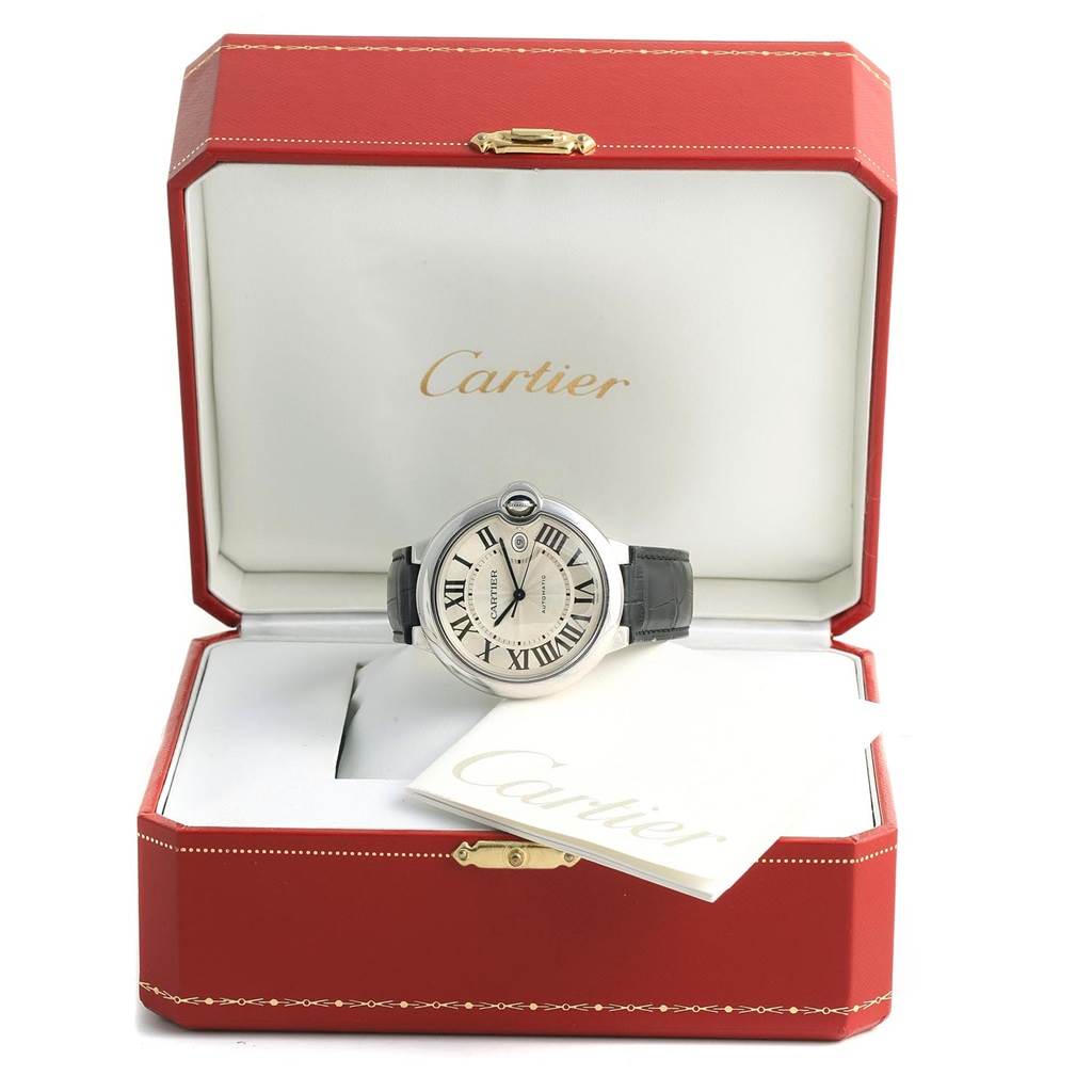 The Cartier Ballon Bleu W69016Z4 Men
s Stainless Steel Silver Dial W69016Z4 Men
s Stainless Steel Silver Dial watch is displayed front-on within an open red box, accompanied by Cartier-branded paperwork.