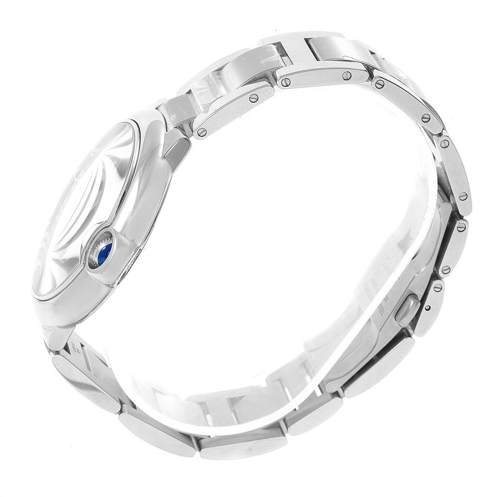 This side-angle view of the Cartier Ballon Bleu W6920042 Men's Stainless Steel Black Dial W6920042 Men's Stainless Steel Black Dial watch shows the bracelet and the crown with a blue sapphire cabochon.