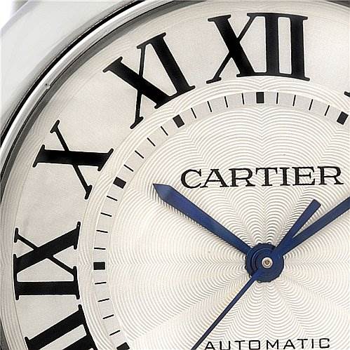 The image shows a close-up of the dial of a Cartier Ballon Bleu W69012Z4 Men's Stainless Steel Silver Dial W69012Z4 Men's Stainless Steel Silver Dial watch, featuring Roman numerals and blue hands.