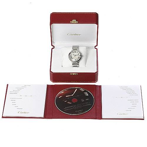 The image shows the Cartier Ballon Bleu W69012Z4 Men's Stainless Steel Silver Dial W69012Z4 Men's Stainless Steel Silver Dial watch in its open box with accompanying documentation and a CD.