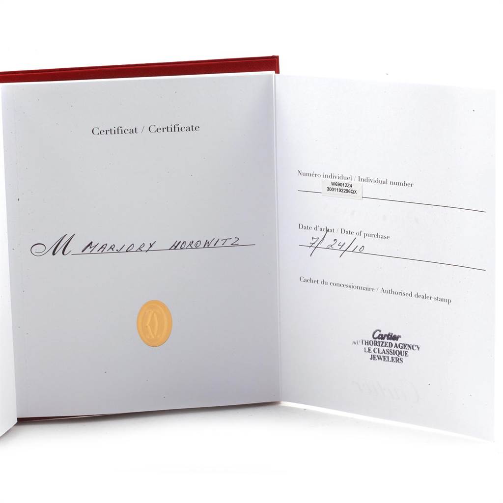 This image shows the certificate open to pages documenting the individual number and purchase date for the Ballon Bleu model by Cartier.