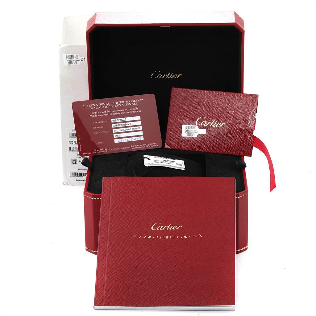 The image shows the packaging and accessories for a Cartier Ballon Bleu WSBB0025 Men
s Stainless Steel Blue Dial WSBB0025 Men
s Stainless Steel Blue Dial model, including the box, warranty card, and booklet.