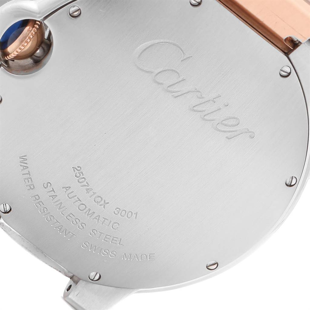 This image shows the back case and crown of the Cartier Ballon Bleu W6920032 Men's Steel and Gold (two tone) Brown Dial W6920032 Men's Steel and Gold (two tone) Brown Dial watch, featuring engraved details and a stainless steel finish.