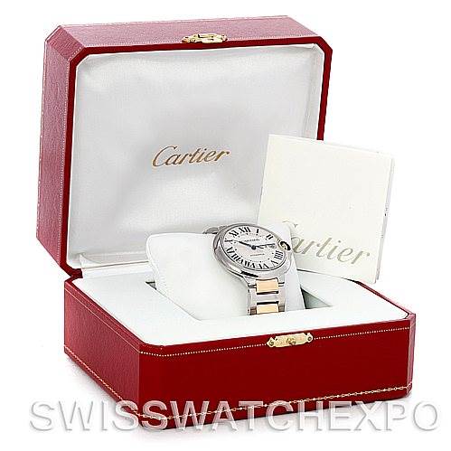 The image displays a Cartier Ballon Bleu W69009Z3 Men's Stainless Steel Silver Dial W69009Z3 Men's Stainless Steel Silver Dial watch placed at an angle inside its red and white branded box, along with accompanying documents.