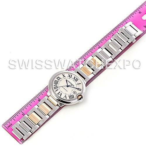 The image shows an overhead view of a Cartier Ballon Bleu W69009Z3 Men's Stainless Steel Silver Dial W69009Z3 Men's Stainless Steel Silver Dial watch with a focus on its face and entire bracelet laid alongside a ruler.