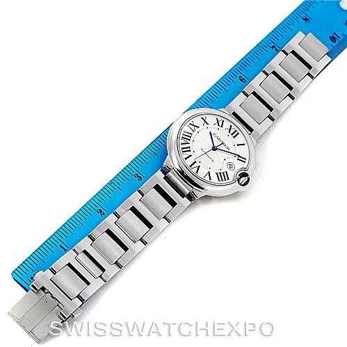 The image shows a Birdseye view of a Cartier Ballon Bleu W69012Z4 Men
s Stainless Steel Silver Dial W69012Z4 Men
s Stainless Steel Silver Dial watch, including its bracelet and clasp, placed next to a ruler for scale.