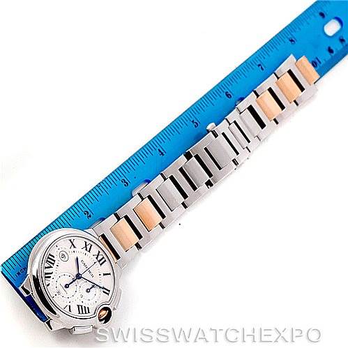 The image shows a top-down view of a Cartier Ballon Bleu W6920063 Men's Steel and Gold (two tone) Silver Dial W6920063 Men's Steel and Gold (two tone) Silver Dial watch with a two-tone metal bracelet and a blue ruler for scale.