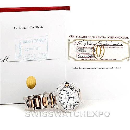 The image shows a Cartier Ballon Bleu W6920063 Men's Steel and Gold (two tone) Silver Dial W6920063 Men's Steel and Gold (two tone) Silver Dial watch at a slightly angled view along with its certificates and warranty documents.