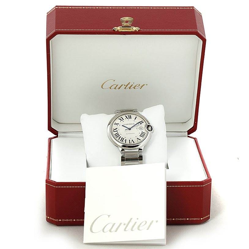 This image shows a Cartier Ballon Bleu W69012Z4 Men's Stainless Steel Silver Dial W69012Z4 Men's Stainless Steel Silver Dial watch placed in an open Cartier box with a Cartier booklet in front.