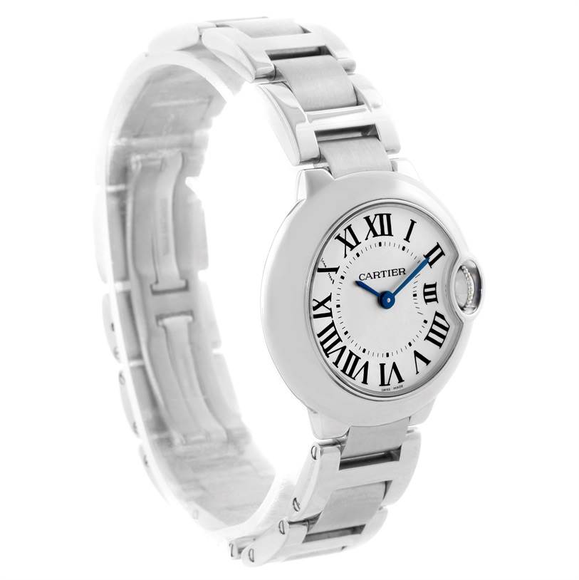 The Ballon Bleu by Cartier is shown at an angled view, highlighting its round face, Roman numerals, and metallic bracelet.