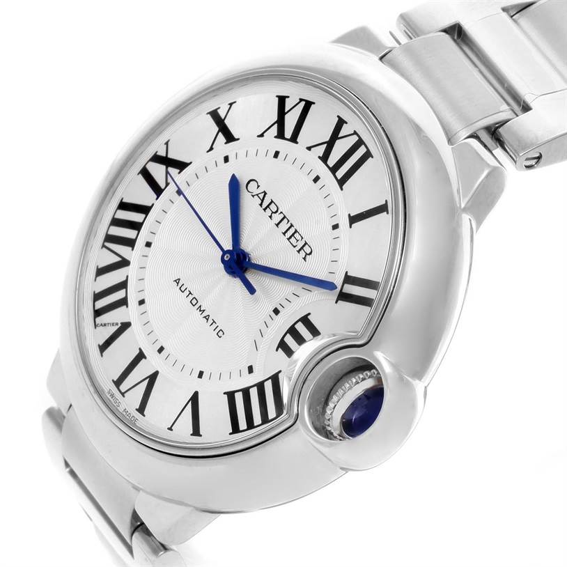 The image shows a close-up, angled view of the Cartier Ballon Bleu W6920046 Women
s Stainless Steel Silver Dial W6920046 Women
s Stainless Steel Silver Dial watch, highlighting its face, Roman numerals, blue hands, and crown.