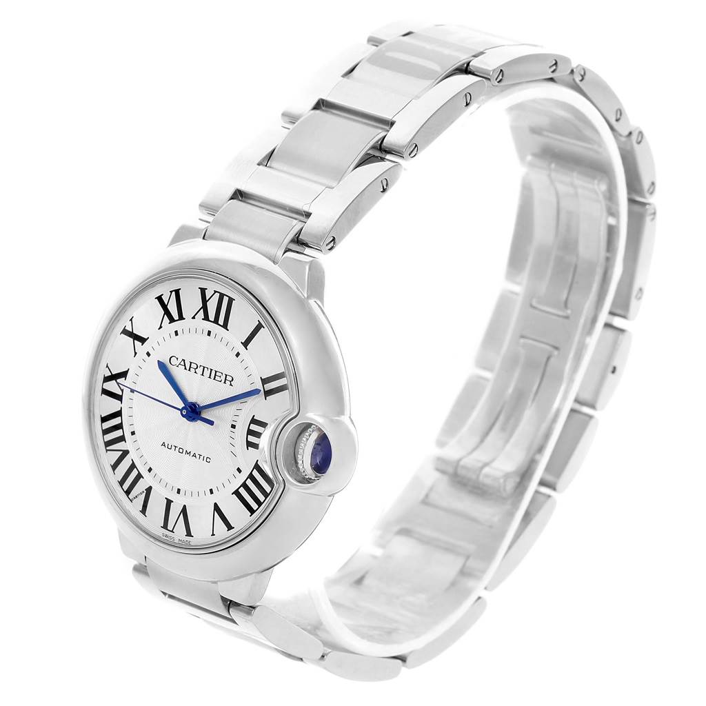 The image shows a side angle of a Ballon Bleu model by Cartier, highlighting the face, crown, and metal bracelet of the watch.