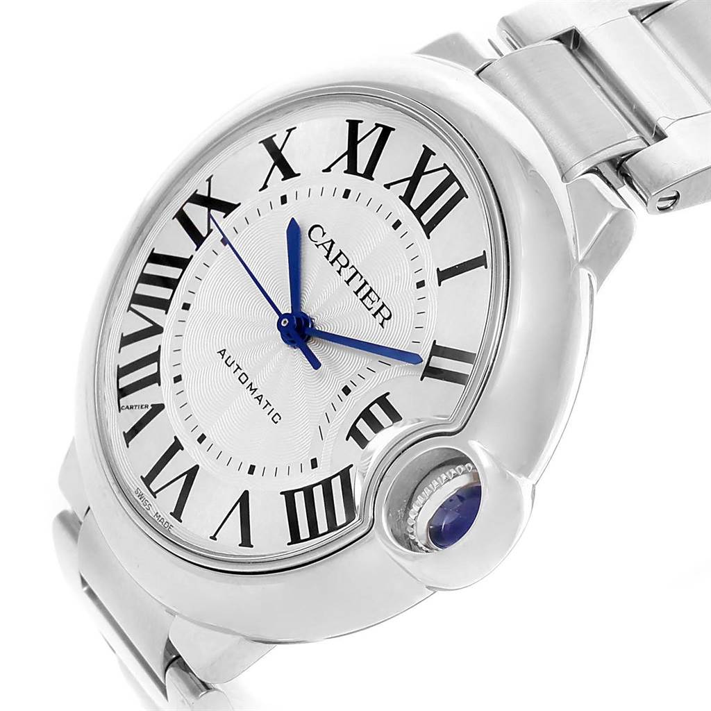 The image shows a close-up of the Cartier Ballon Bleu W6920046 Women
s Stainless Steel Silver Dial W6920046 Women
s Stainless Steel Silver Dial watch, highlighting the dial, Roman numerals, and blue hands, with a side view of the crown.